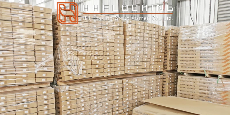 Shrink-wrapped pallets of square parquet flooring tiles and SPC products ready for global shipment at the HH Flooring Group Xiamen warehouse. Shrink-wrapped pallets of square parquet flooring tiles and SPC products ready for global shipment at the HH Flooring Group Xiamen warehouse.